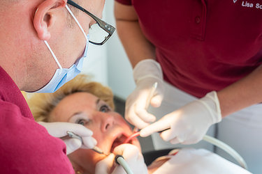 Ein Zahnarzt untersucht eine Patientin